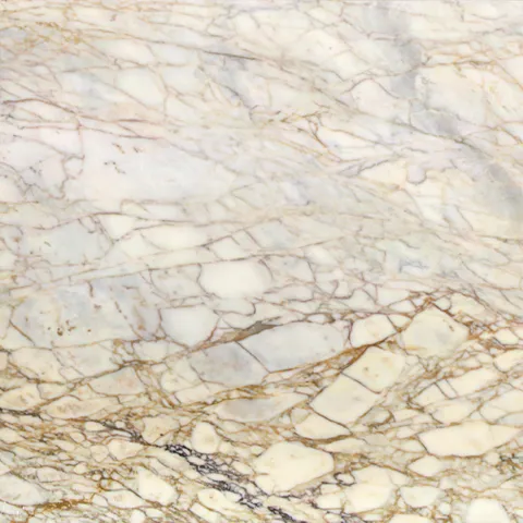 Close-up of Karyamar’s White Gold natural stone with a soft white background and elegant gold veining, ideal for luxurious interior designs.