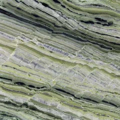 Close-up of Karyamar’s Emerald Forest natural stone, showcasing deep green hues and natural veining, perfect for luxury interiors and architectural applications