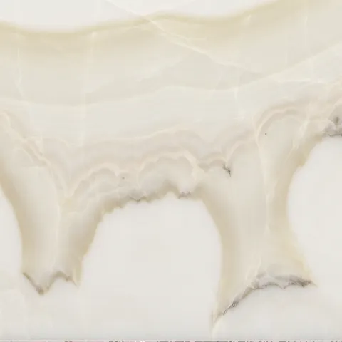 Close-up of Karyamar’s True White Onyx natural stone, showcasing its pure white translucency and delicate veining, perfect for backlit luxury interior applications