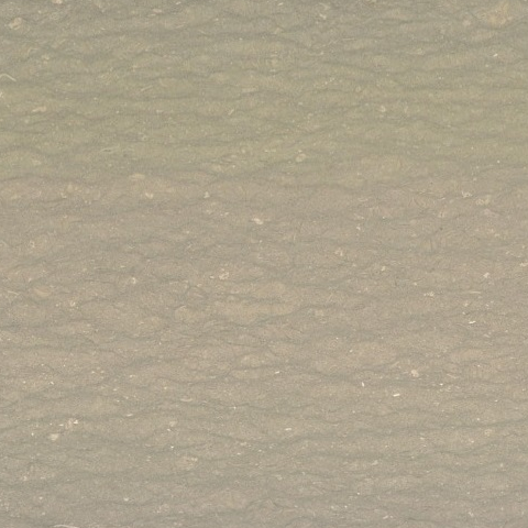 Close-up of Karyamar’s Sage Rustique natural stone with sage green hues and warm rust veining, perfect for luxury architectural and interior applications