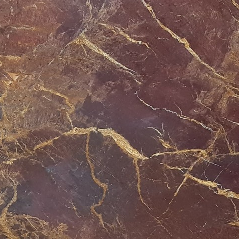 Close-up of Karyamar’s Golden Cherry natural stone with deep golden and cherry tones, perfect for luxurious architectural and interior applications