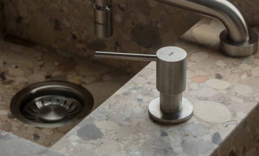 Close-up of Karyamar’s Beige Conglomerate natural stone with warm beige tones and dynamic natural aggregates, ideal for architectural and interior applications