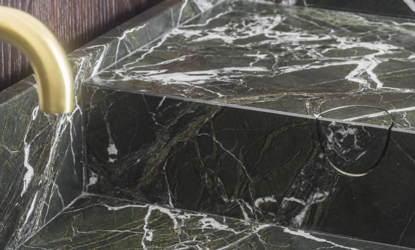 Close-up of Karyamar’s Flame Green natural stone, showcasing bold green hues and dynamic veining, ideal for high-end architectural and interior applications.