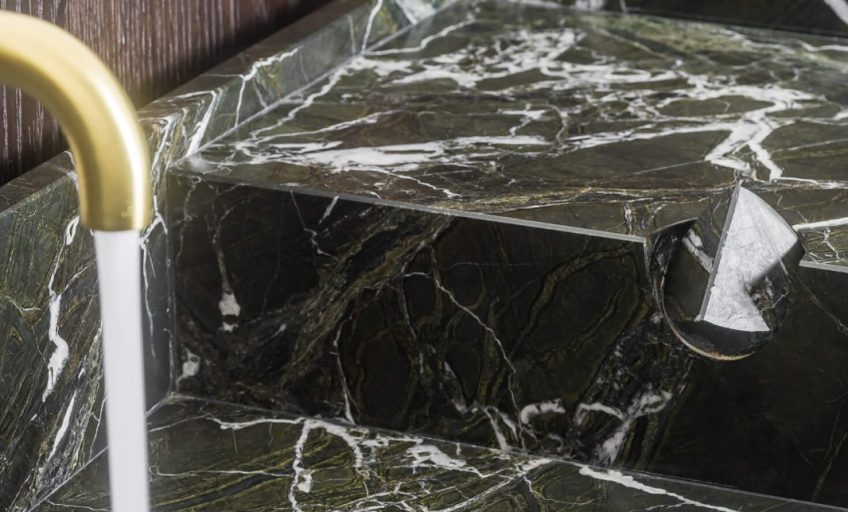 Close-up of Karyamar’s Flame Green natural stone, showcasing bold green hues and dynamic veining, ideal for high-end architectural and interior applications.