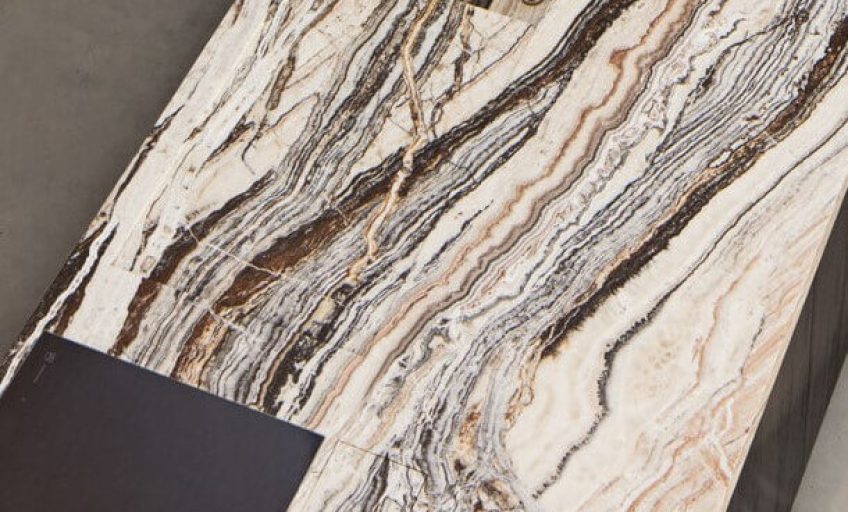 Close-up of Karyamar’s Jurassic Traonyx natural stone, showcasing fossil-inspired patterns and translucent properties, perfect for luxury interiors and architectural designs